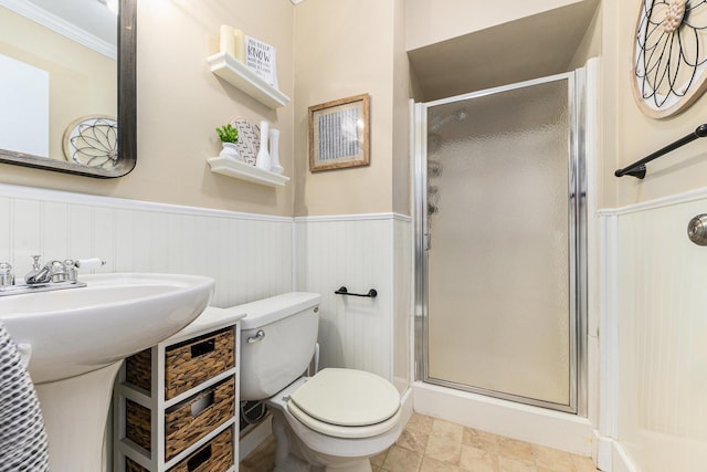 411 Edgemoor Ave, Kalamazoo, MI 49001 - bathroom with wainscoting, a stall shower, and stone finish floors
