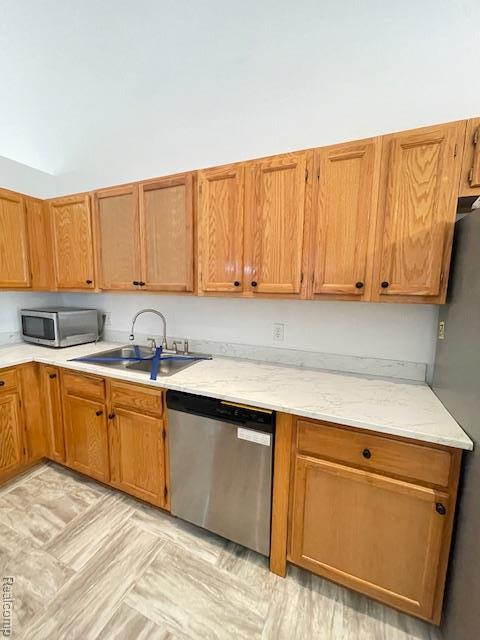 30885 Lee Frank Ln, Madison Heights, MI 48071 - kitchen featuring appliances with stainless steel finishes, light stone counters, and brown cabinets