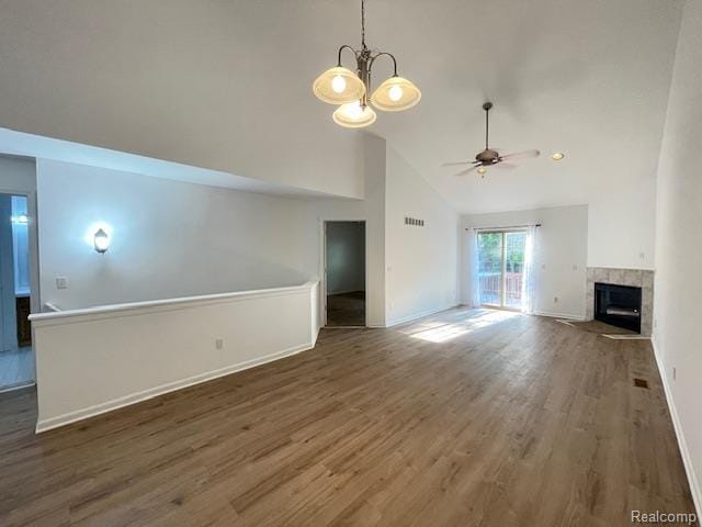 30885 Lee Frank Ln, Madison Heights, MI 48071 - unfurnished living room featuring a ceiling fan, a fireplace, wood finished floors, a chandelier, and high vaulted ceiling