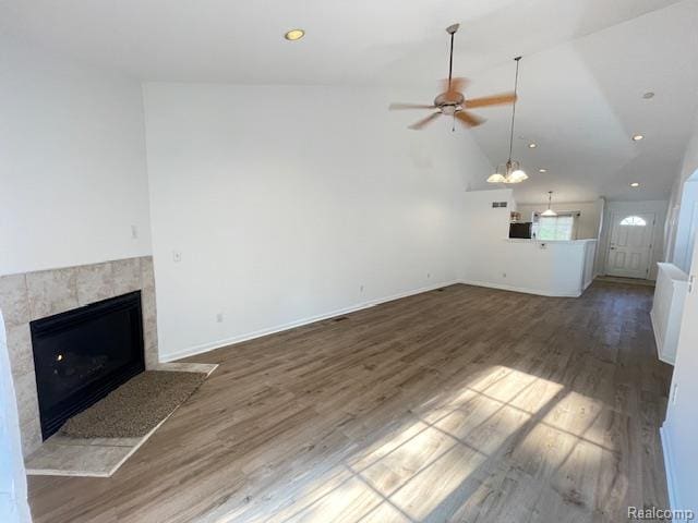 30885 Lee Frank Ln, Madison Heights, MI 48071 - unfurnished living room with a ceiling fan, a tile fireplace, wood finished floors, lofted ceiling, and recessed lighting