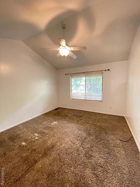 30885 Lee Frank Ln, Madison Heights, MI 48071 - empty room with vaulted ceiling, carpet, and a ceiling fan