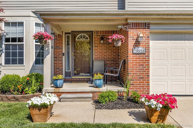 29520 Hunter St, Trenton, MI 48183 - entrance to property featuring a porch, brick siding, and a garage