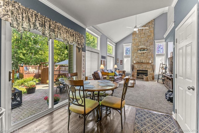 29520 Hunter St, Trenton, MI 48183 - dining area featuring ceiling fan, a stone fireplace, lofted ceiling, wood finished floors, and ornamental molding