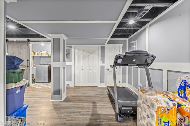 29520 Hunter St, Trenton, MI 48183 - exercise room featuring washer / clothes dryer, wood finished floors, and a barn door