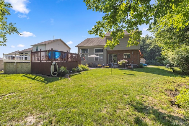 29520 Hunter St, Trenton, MI 48183 - rear view of property with a wooden deck, a yard, and brick siding