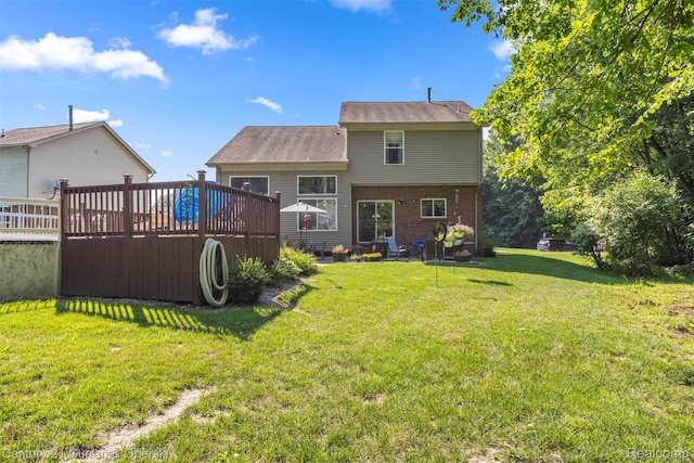 29520 Hunter St, Trenton, MI 48183 - back of property featuring a wooden deck, a yard, and brick siding