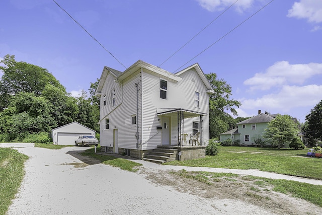 1211 S Jackson St, Jackson, MI 49203 - view of front facade featuring an outbuilding, a detached garage, and a front lawn