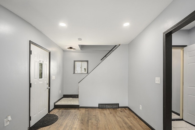 1211 S Jackson St, Jackson, MI 49203 - foyer entrance featuring light wood-style floors, recessed lighting, and stairway