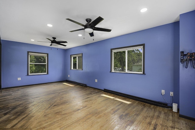 1211 S Jackson St, Jackson, MI 49203 - spare room featuring healthy amount of natural light, ceiling fan, wood finished floors, and recessed lighting