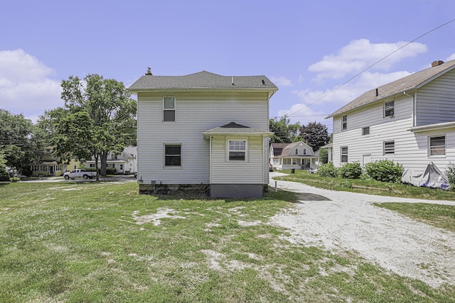 1211 S Jackson St, Jackson, MI 49203 - view of side of home with a lawn