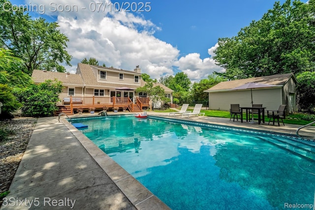 4375 Island Park Dr, Waterford, MI 48329 - swimming pool with a wooden deck and outdoor dining space