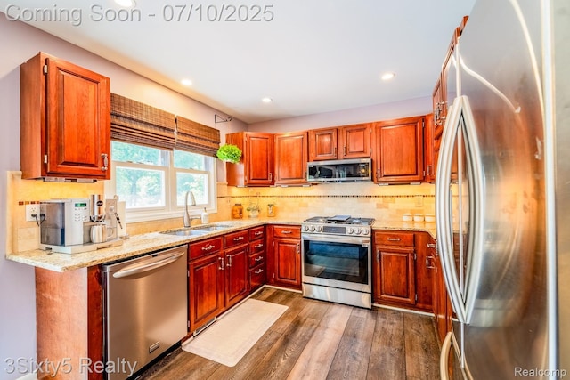4375 Island Park Dr, Waterford, MI 48329 - kitchen featuring stainless steel appliances, dark wood-style flooring, backsplash, light stone counters, and recessed lighting