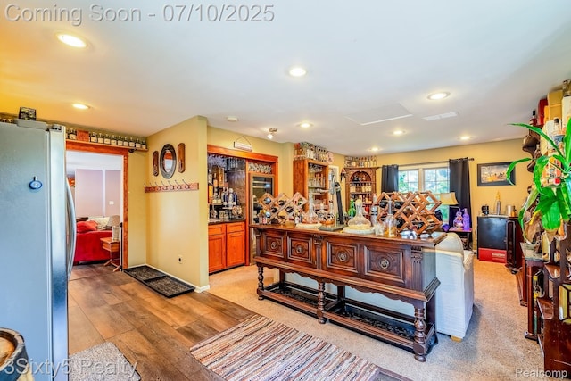 4375 Island Park Dr, Waterford, MI 48329 - living room with light wood-style floors, recessed lighting, attic access, and a bar