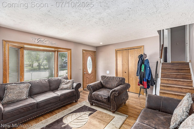 41173 Cimarron St, Clinton Township, MI 48038 - living room with a textured ceiling, wood finished floors, and stairway