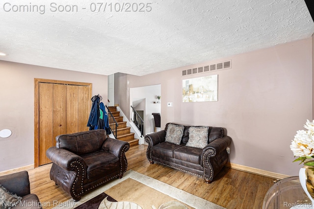 41173 Cimarron St, Clinton Township, MI 48038 - living area with wood finished floors, a textured ceiling, and stairway