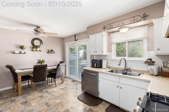 41173 Cimarron St, Clinton Township, MI 48038 - kitchen with stainless steel dishwasher, gas range oven, backsplash, and light countertops