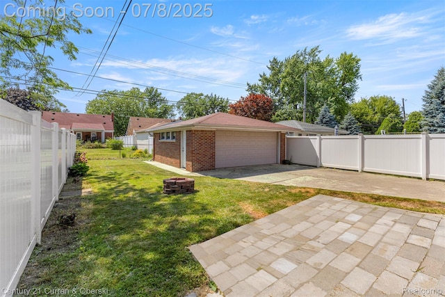8960 Niver Ave, Allen Park, MI 48101 - fenced backyard with a garage, a patio, and a fire pit