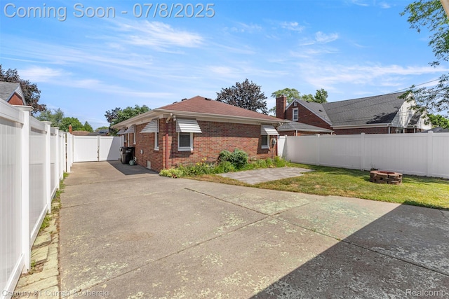 8960 Niver Ave, Allen Park, MI 48101 - back of house featuring a fire pit, brick siding, a fenced backyard, a patio, and a gate