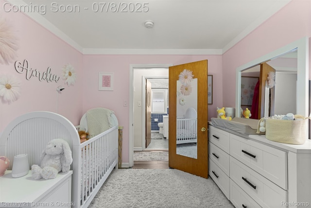 8960 Niver Ave, Allen Park, MI 48101 - bedroom featuring ornamental molding, a crib, light colored carpet, and light wood-type flooring