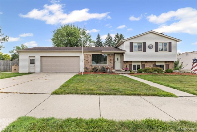 22031 Birch St, Woodhaven, MI 48183 - split level home with a garage, concrete driveway, and brick siding