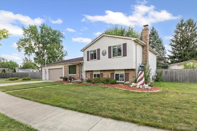 22031 Birch St, Woodhaven, MI 48183 - tri-level home with an attached garage, concrete driveway, a chimney, and brick siding