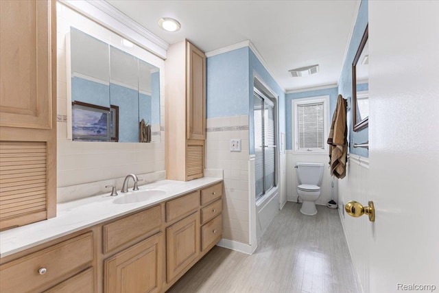 22031 Birch St, Woodhaven, MI 48183 - bathroom featuring tile walls, wood finished floors, vanity, and enclosed tub / shower combo