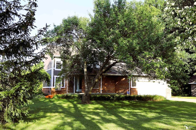 13578 Strasburg Rd, La Salle, MI 48145 - view of property hidden behind natural elements featuring brick siding and a front yard