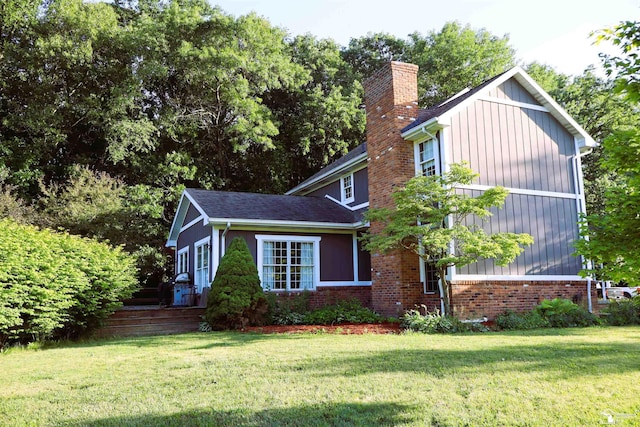 13578 Strasburg Rd, La Salle, MI 48145 - view of side of home featuring a chimney and a yard