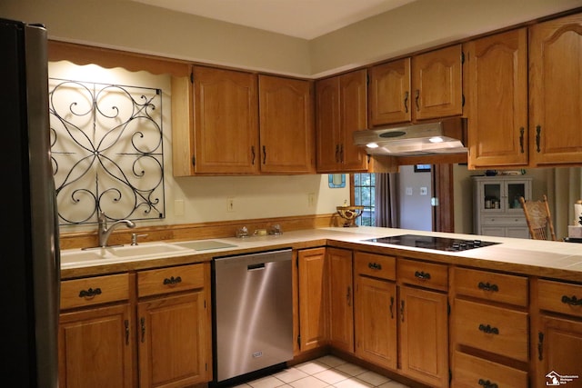 13578 Strasburg Rd, La Salle, MI 48145 - kitchen with dishwasher, under cabinet range hood, black electric stovetop, and brown cabinets