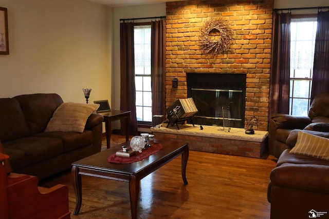 13578 Strasburg Rd, La Salle, MI 48145 - living area featuring wood finished floors, a fireplace, and plenty of natural light