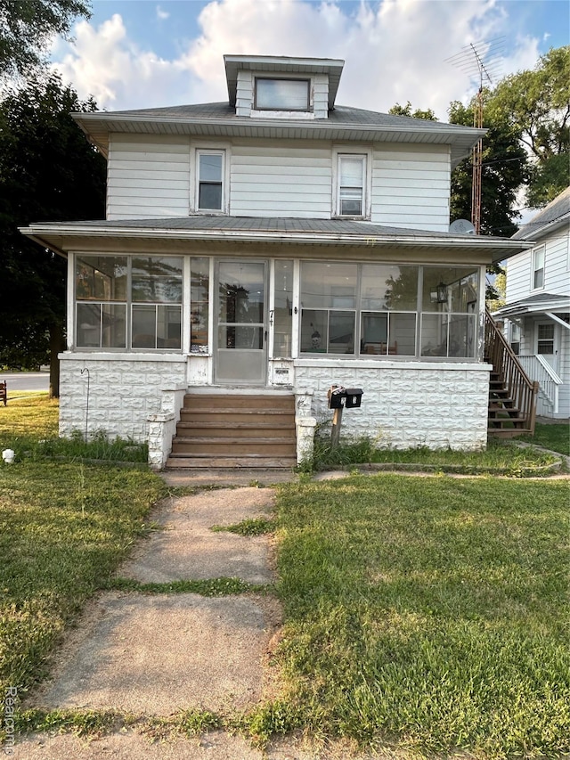 7 E Noble Ave, Monroe, MI 48162 - american foursquare style home with a sunroom, stone siding, entry steps, and a front lawn