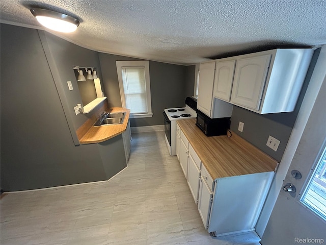 7 E Noble Ave, Monroe, MI 48162 - kitchen featuring white electric range, a textured ceiling, white cabinets, and vaulted ceiling