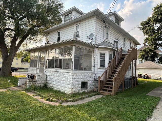 7 E Noble Ave, Monroe, MI 48162 - view of side of property with stairway, a yard, and a sunroom