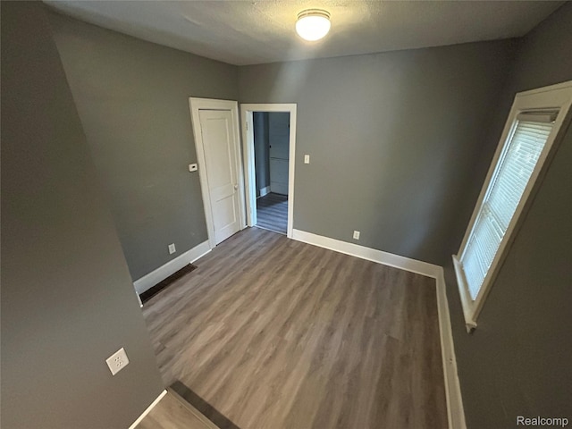 7 E Noble Ave, Monroe, MI 48162 - empty room with baseboards and wood finished floors