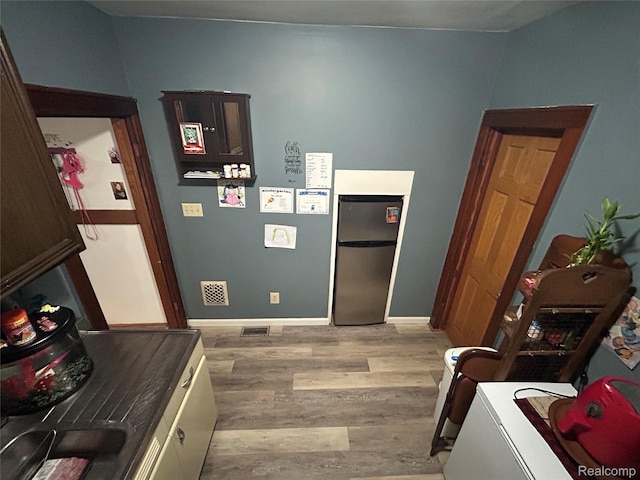 7 E Noble Ave, Monroe, MI 48162 - kitchen with freestanding refrigerator and light wood-style floors