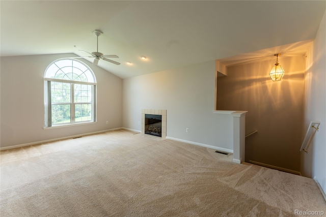 2165 Leighton Dr, Shelby Twp, MI 48317 - unfurnished living room featuring carpet flooring, vaulted ceiling, a tile fireplace, and ceiling fan