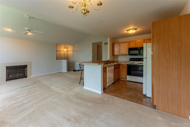 2165 Leighton Dr, Shelby Twp, MI 48317 - kitchen with white appliances, vaulted ceiling, light colored carpet, a peninsula, and open floor plan