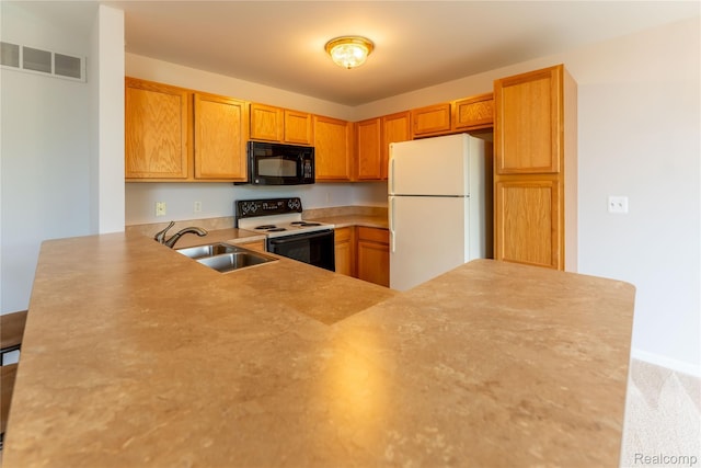 2165 Leighton Dr, Shelby Twp, MI 48317 - kitchen with freestanding refrigerator, range with electric cooktop, black microwave, a peninsula, and light countertops