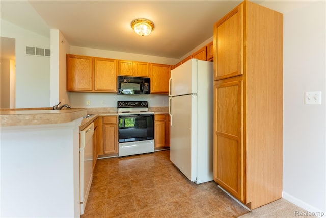 2165 Leighton Dr, Shelby Twp, MI 48317 - kitchen featuring white appliances, light countertops, and a peninsula