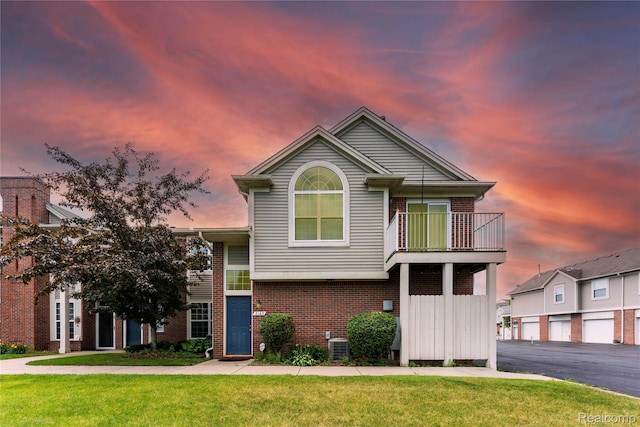 2165 Leighton Dr, Shelby Twp, MI 48317 - view of front facade with brick siding, a balcony, and a front yard