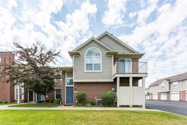 2165 Leighton Dr, Shelby Twp, MI 48317 - view of front of property with brick siding, a balcony, and a front lawn