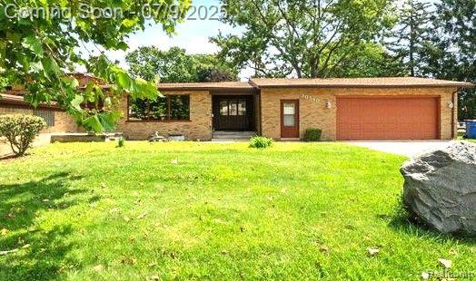 30590 Lorraine Ave, Warren, MI 48093 - ranch-style home featuring an attached garage, a front yard, and concrete driveway