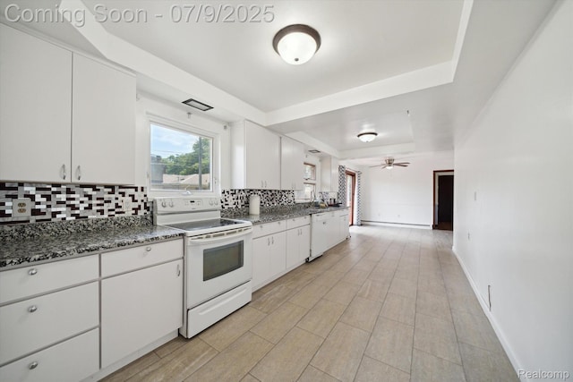 30590 Lorraine Ave, Warren, MI 48093 - kitchen with white appliances, a tray ceiling, tasteful backsplash, white cabinetry, and ceiling fan