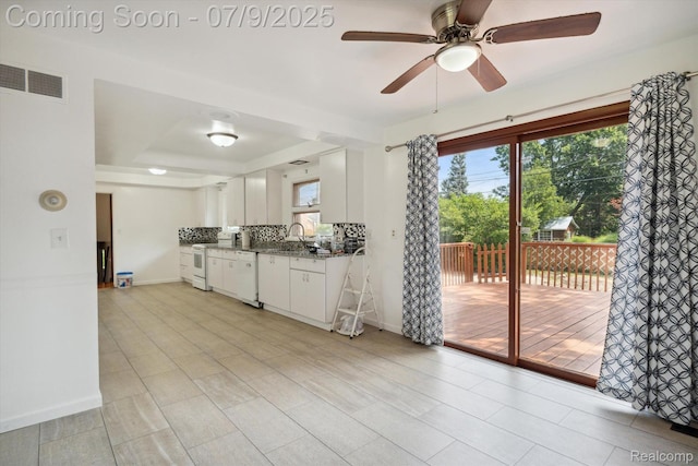 30590 Lorraine Ave, Warren, MI 48093 - kitchen with white appliances, ceiling fan, white cabinets, and tasteful backsplash