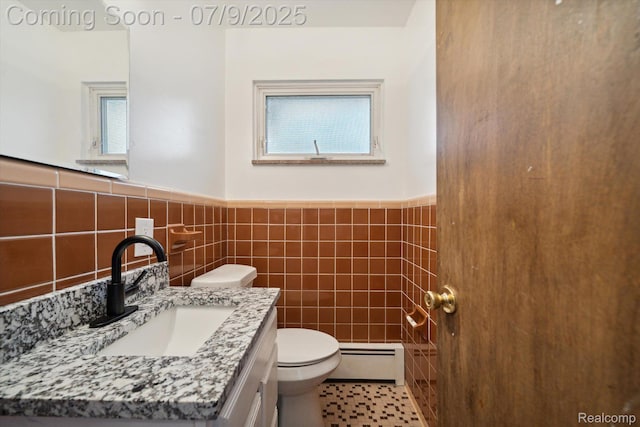 30590 Lorraine Ave, Warren, MI 48093 - bathroom with a baseboard radiator, vanity, a wainscoted wall, and tile walls