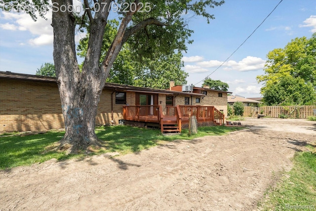 30590 Lorraine Ave, Warren, MI 48093 - rear view of property with brick siding, a deck, a chimney, and driveway