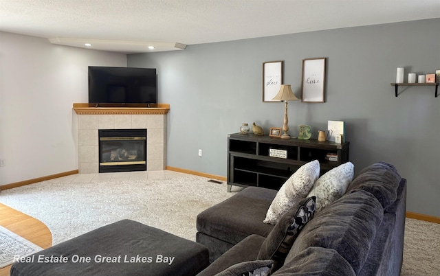 11540 Saddlebrook Cir, Freeland, MI 48623 - living area featuring carpet flooring, a tiled fireplace, and recessed lighting
