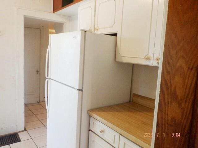 2535 Gull Rd, Kalamazoo, MI 49048 - kitchen featuring freestanding refrigerator, white cabinets, light tile patterned flooring, and light countertops