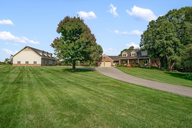 3603 Elk Ct, Zeeland, MI 49464 - view of grassy yard featuring a garage and concrete driveway
