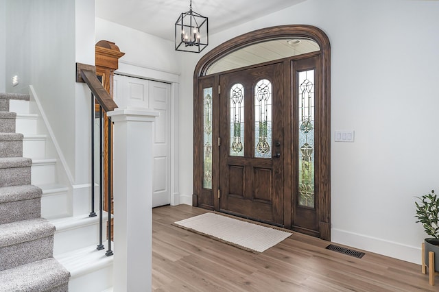 3603 Elk Ct, Zeeland, MI 49464 - entryway featuring stairway, healthy amount of natural light, wood finished floors, and a chandelier